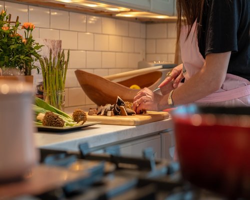 Person meal prepping fresh ingredients in a kitchen
